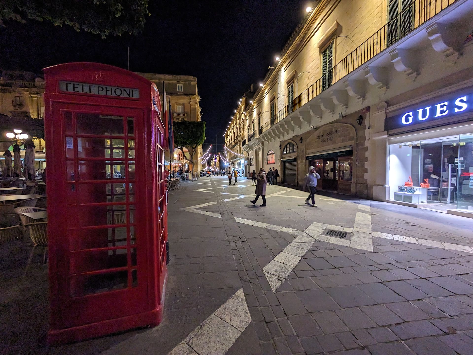 Valletta Red telephone box on a Valletta street at night