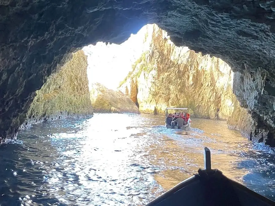 Boat leaving a cave of the Blue Grotto of Malta