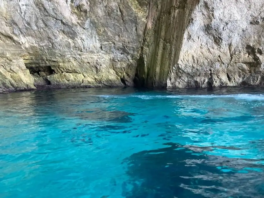 Cliffs and turquoise water of the Blue Grotto in Malta